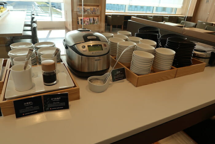 a kitchen counter with a stack of plates and a crock pot