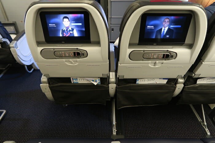 two seats with a television on the back