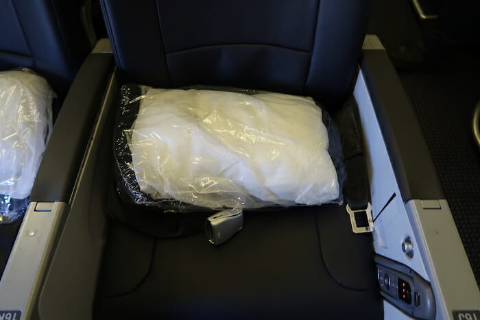 a white pillow in a plastic bag on a seat