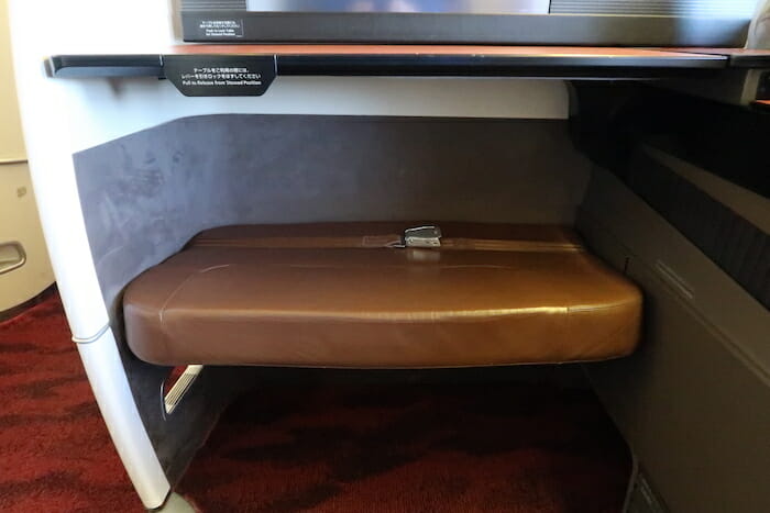 a brown seat under a desk