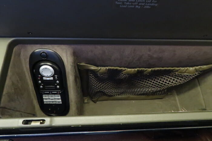 a phone in a small storage compartment