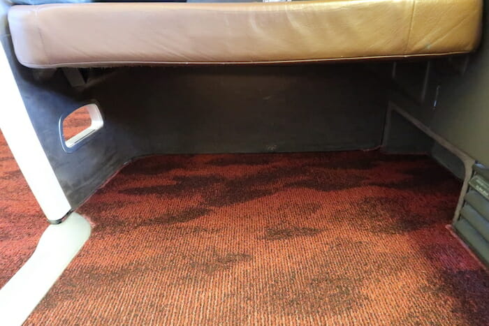 a brown carpet with a tan cushion