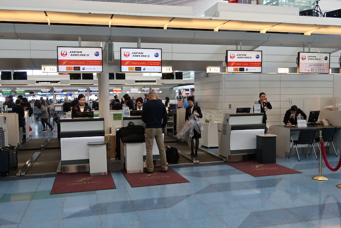 people at an airport check in counter