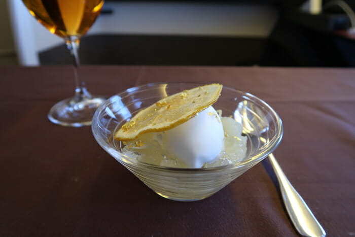 a bowl of ice cream with a lemon wedge in it