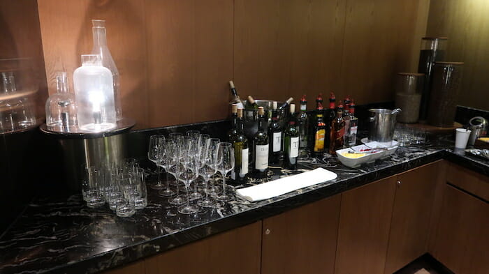 a table with wine bottles and glasses