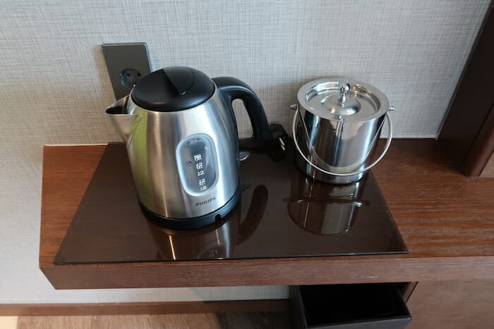 a coffee pot and a bucket on a table