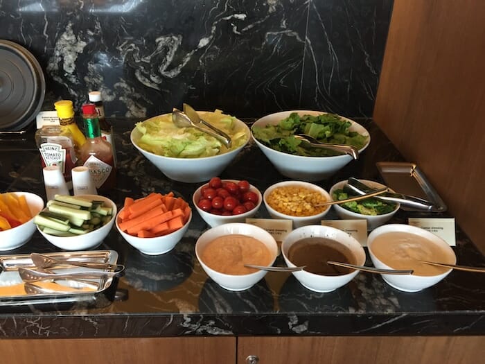 a table with bowls of food and sauces