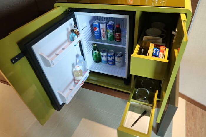 a mini fridge with drinks and snacks