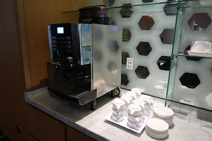 a coffee machine and plates on a counter