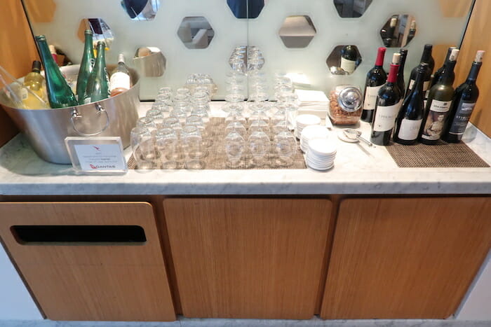 a group of wine glasses and bottles on a counter