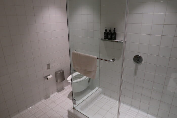 a bathroom with a glass shower door