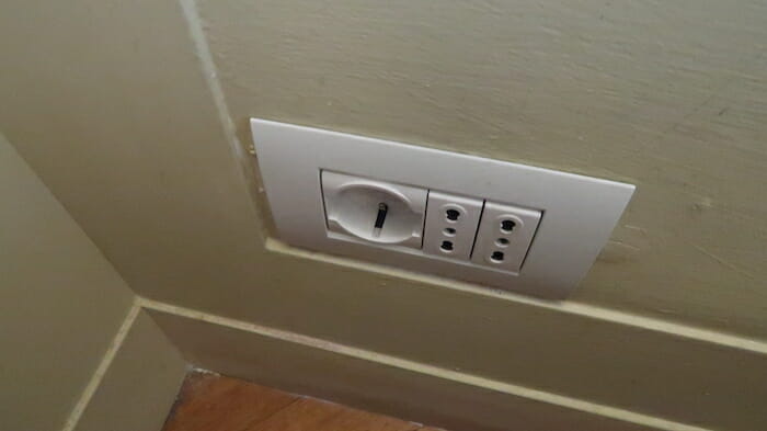 a white outlet with a keyhole