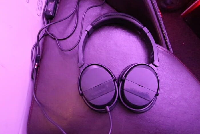 a pair of headphones on a leather surface