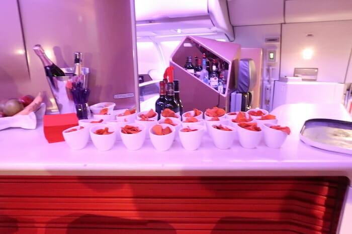 a group of white bowls of chips on a table