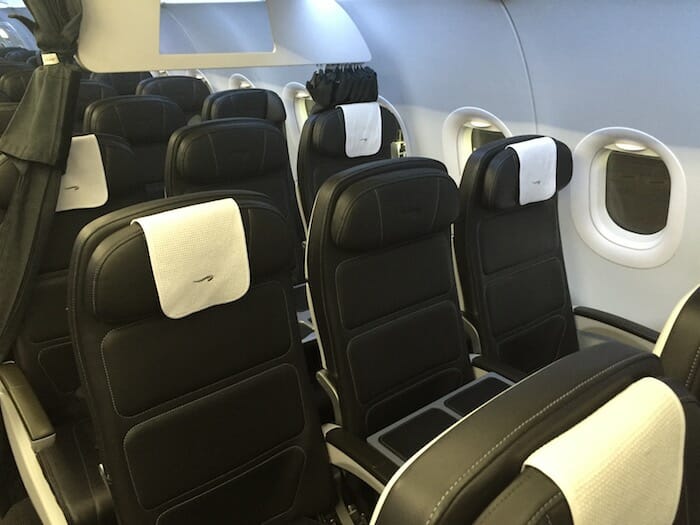 a row of black and white seats in an airplane