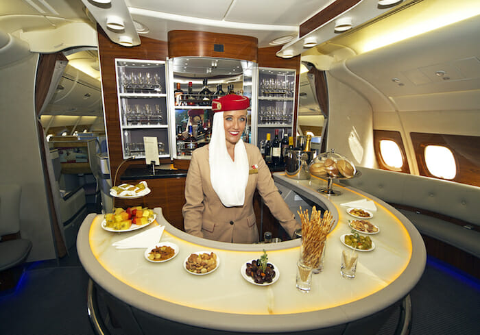 a woman standing behind a counter in an airplane