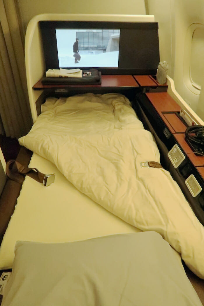 a bed with a tv in the back of it