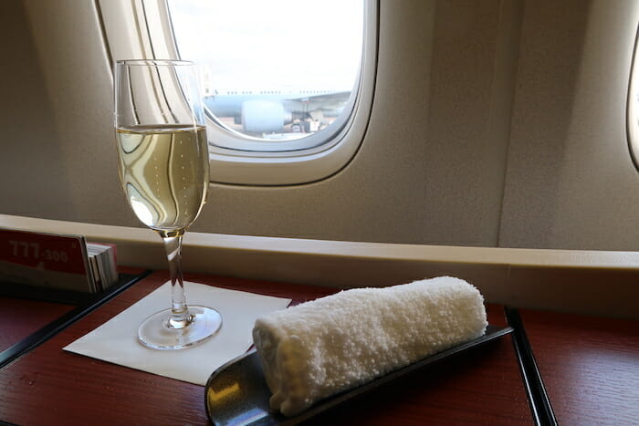 a glass of wine and a towel on a tray