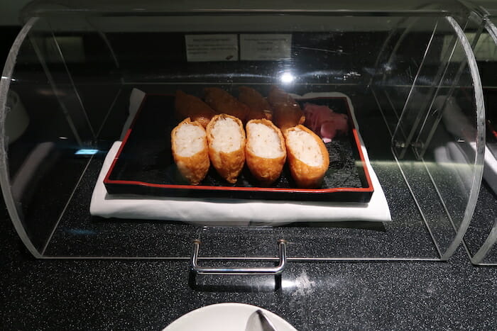 food on a tray in a glass case