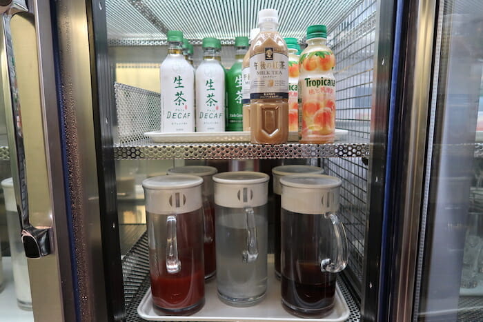 a refrigerator with bottles of liquid and drinks