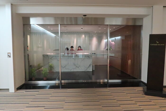 a glass door with a counter and people behind it