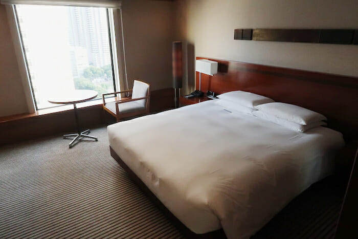 a hotel room with a bed and chair