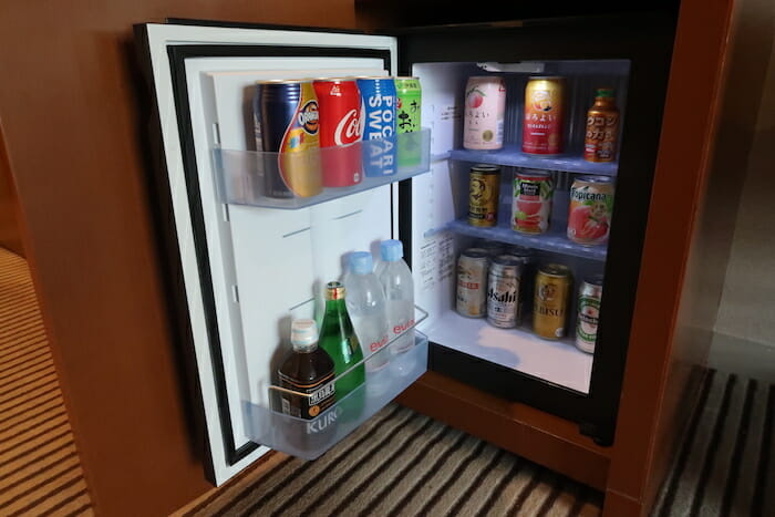 a refrigerator with drinks and cans