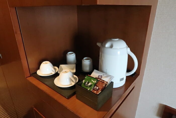 a teapot and cups on a counter