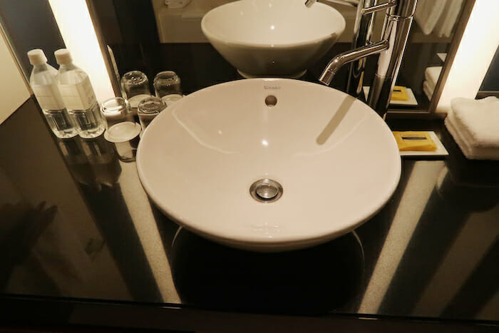 a white sink on a black counter