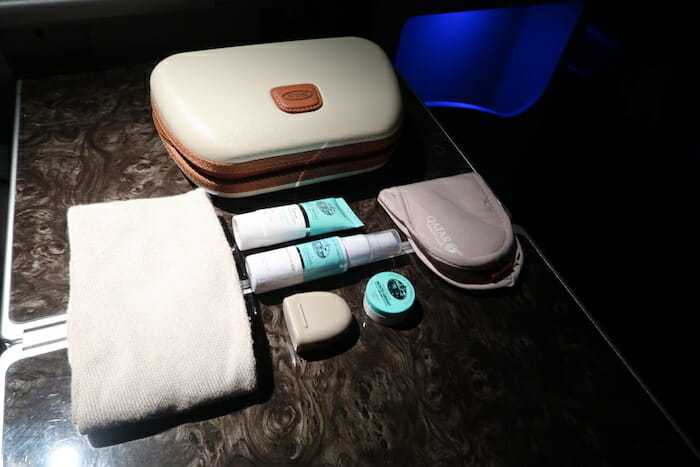 a group of toiletries and a bag on a table