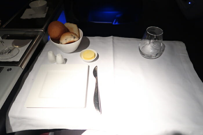 a plate with food in bowl and butter on a table