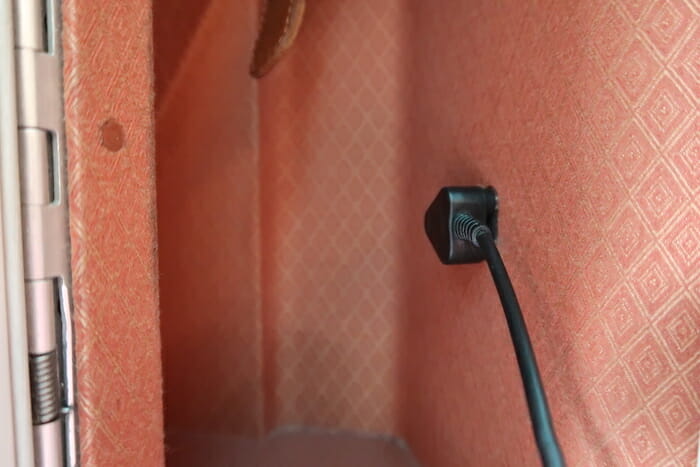 a black cord plugged into a wall