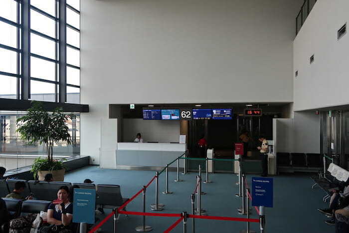 people sitting in chairs in an airport