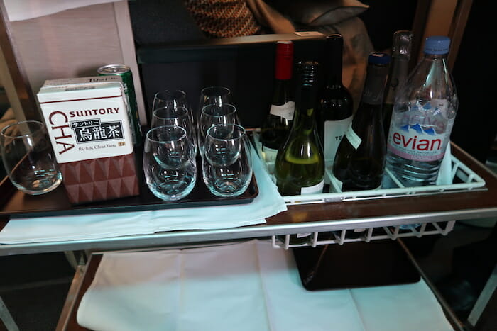 a tray with wine glasses and bottles on it