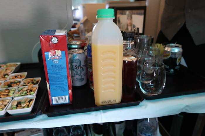 a tray with a bottle of juice and drinks on it