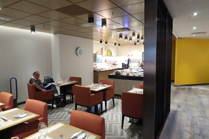 a man sitting at tables in a restaurant