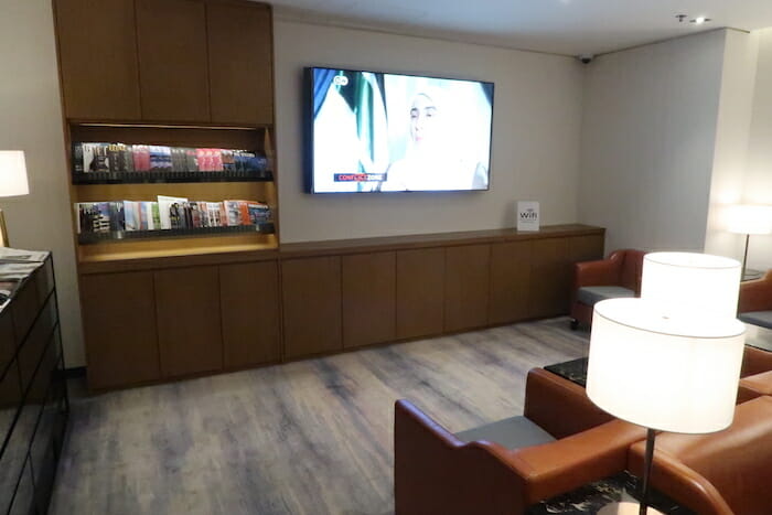 a room with a television and shelves