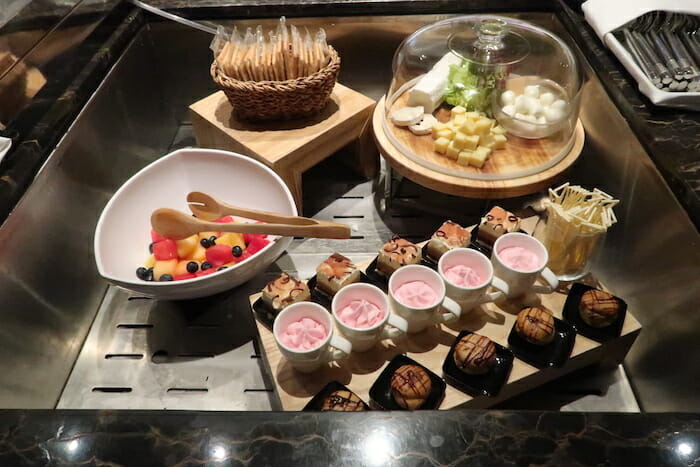 a tray of food and desserts