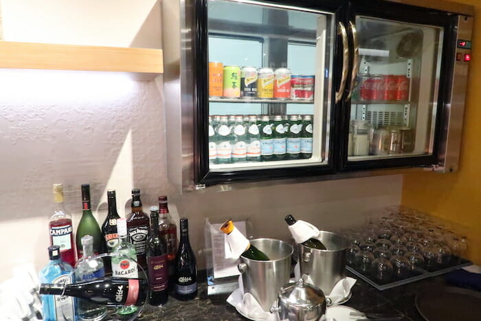 a fridge with bottles of alcohol and drinks