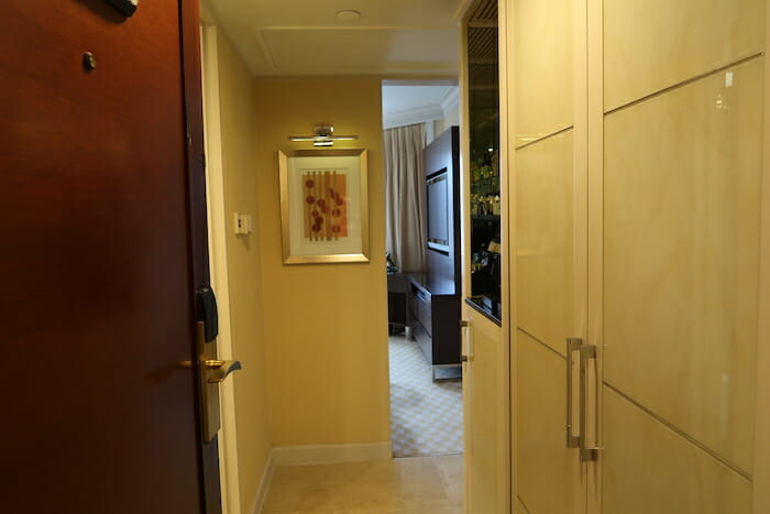 a hallway with a tv and a wood door