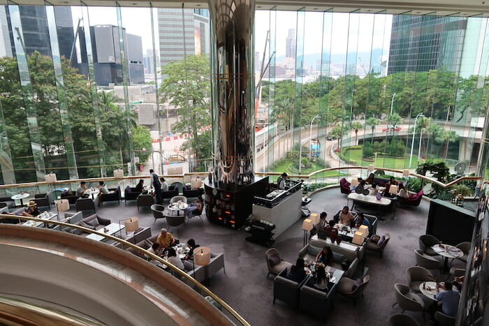 a large room with tables and chairs and a large pillar