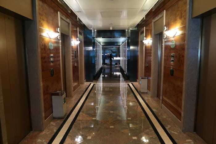 a hallway with elevators and lights