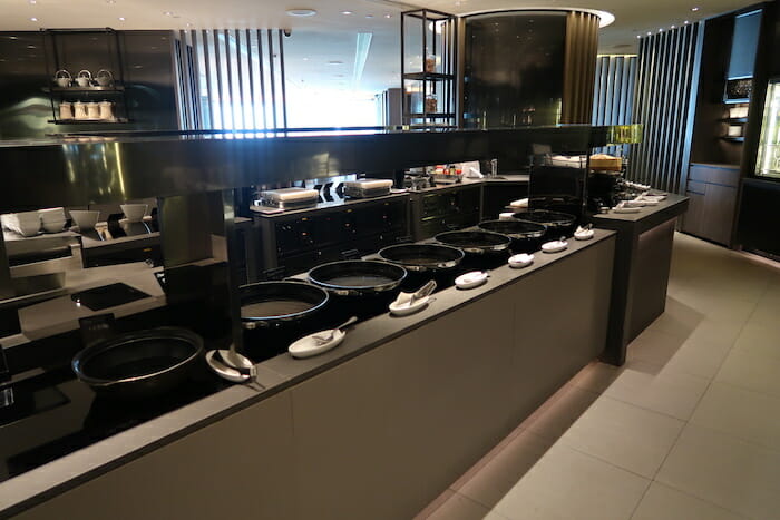 a row of black bowls on a counter