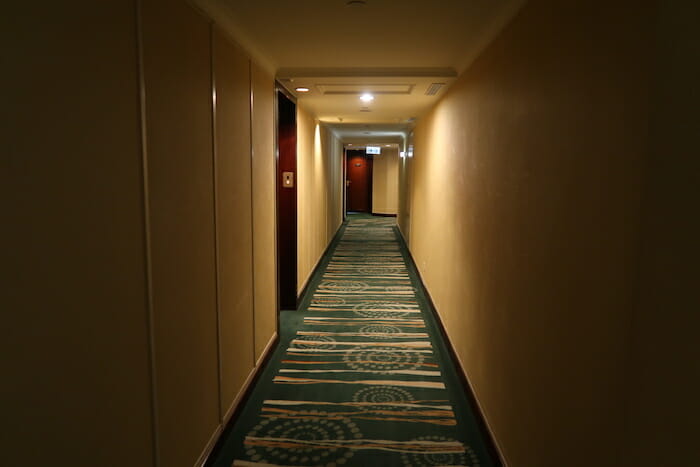 a long hallway with carpet and doors