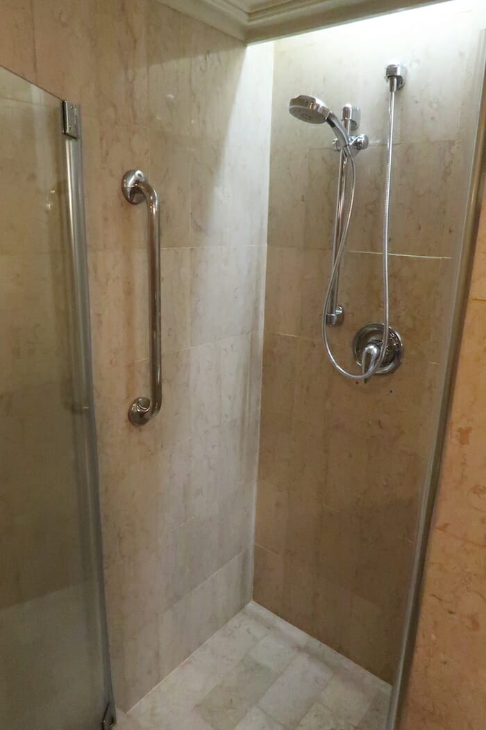 a shower with a hand held shower