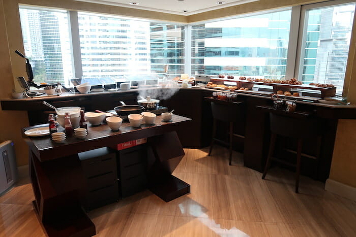 a kitchen with many dishes and food on the counter