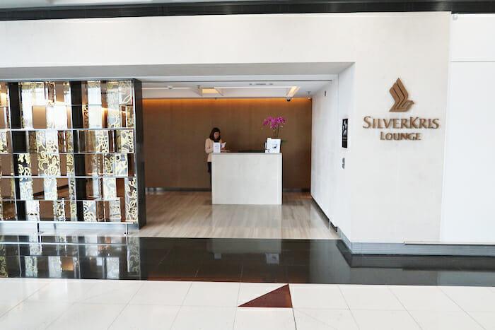 a woman standing at a reception desk in a lobby