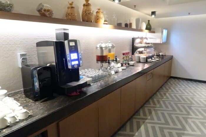 a counter with a coffee machine and a coffee maker