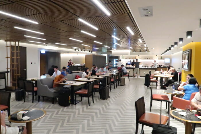 a group of people sitting at tables in a restaurant