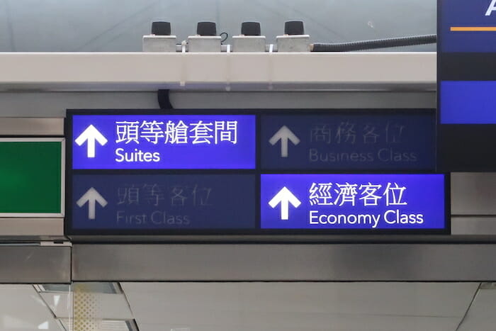 a sign with white arrows and blue text